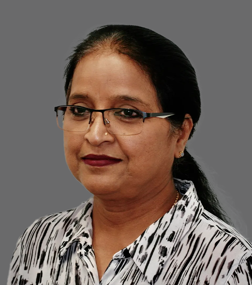 Sumana Kodi, Practice Manager at ZenWaves Clinic Sydney, wearing glasses and a black and white shirt, professional staff profile photo on a grey background.
